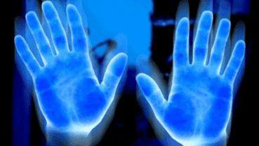 A close up of two hands with blue light coming from them